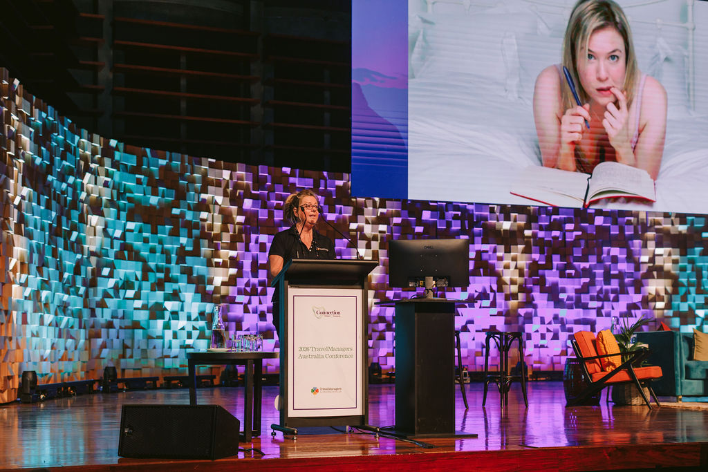 woman presenting on stage