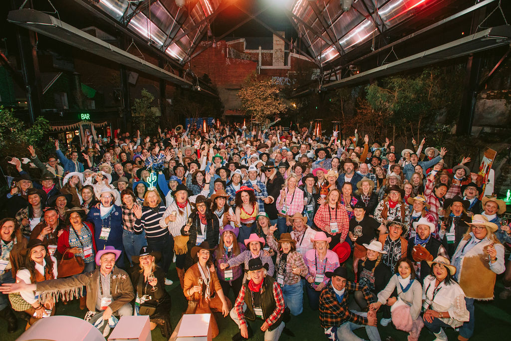 group shot of TravelManagers at a cowboy themed evening at a conference