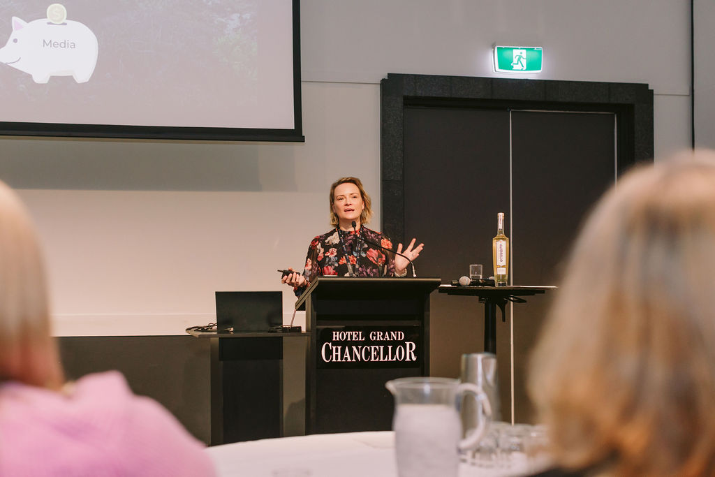 woman presenting at conference